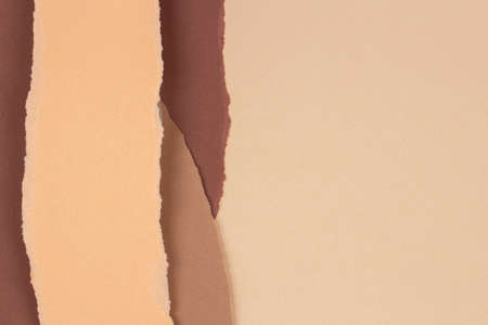 Torn grunge ripped beige brown geometric paper background. Colorful torn paper collage wallpaperの写真素材