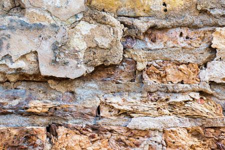 Old cracked weathered plastered brick wall background texture. Dirty peeled plaster wall with...