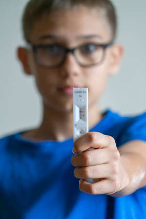 Kid show rapid Coronavirus Covid-19 negative test device with negative test resultの写真素材
