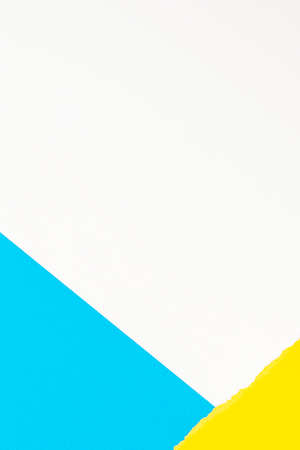 Torn grunge ripped yellow paper and light blue paper on white background. Colorful paper vertical collageの写真素材