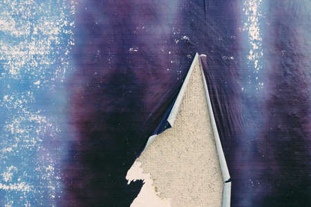 Old white grunge ripped torn collage posters creased crumpled paper placard on the wall backgroundの写真素材