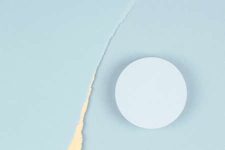 Top view to geometric round shape podium for product display, pastel yellow and light blue torn paper backgroundの写真素材