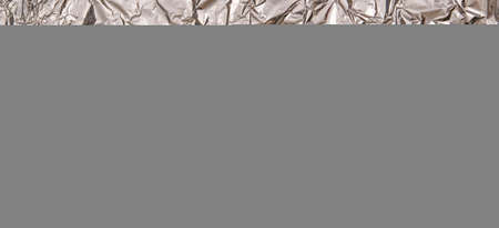 Silver shiny crumpled foil texture background. Top viewの写真素材
