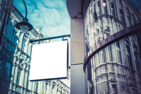 Mock up. Blank white rectangular shape signboard on the wall of classical architecture building. Signage of shop, store, cafe, restaurantの写真素材