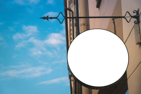 Mock up. Blank white round shape signboard on the wall outdoors. Signage of shop, store, cafe,...