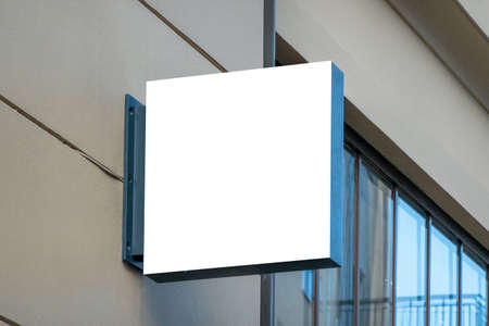 Mock up. Blank white rectangular shape signboard on the wall outdoors. Signage of shop, store, cafe, restaurantの写真素材