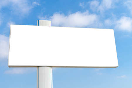 Mock up of big horizontal blank white billboard on blue sky with white clouds backgroundの写真素材