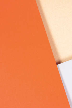 Creative abstract geometric brown craft paper and colored paper background in orange, light gray colors. Top view, copy space.の写真素材