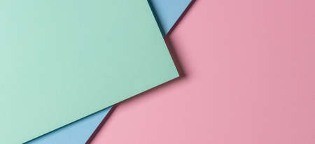 Abstract creative geometric pastel pink, light green and blue paper background with copy spaceの写真素材
