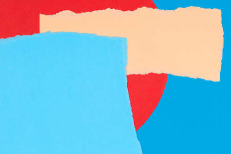 Torn paper textured collage background. Grunge ripped pastel paper pieces with ragged edge on geometric blue and red paper backgroundの写真素材