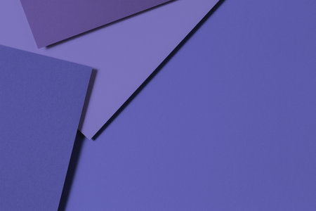 Abstract colored paper geometry composition banner background in very peri, purple color. Top view