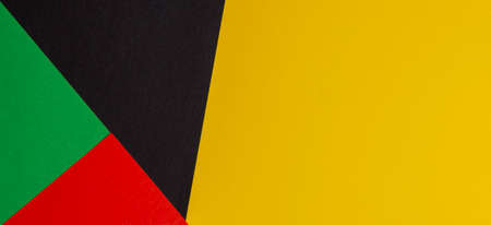 Abstract colored paper geometry composition banner background in black, red, yellow, green colors with copy space for textの写真素材
