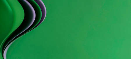 Abstract colored paper geometry composition banner background. Purple and green color curved lines and shapes on green backgroundの写真素材