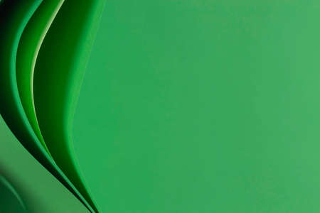 Abstract monochrome paper geometry composition background. Curved lines and shapes on green backgroundの写真素材