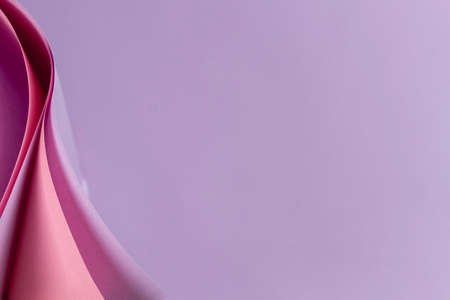 Abstract colored paper geometry composition background in violet, purple, magenta, pink color with...