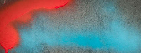 Fragment of the wall with blue red colors graffiti painting. Part of colorful street art graffiti on...