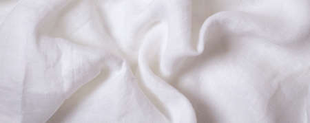 White crumpled linen fabric texture background. Natural linen canvas organic eco textiles...