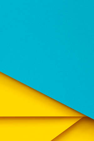 Abstract color papers geometry flat lay composition background with light blue and yellow tonesの写真素材