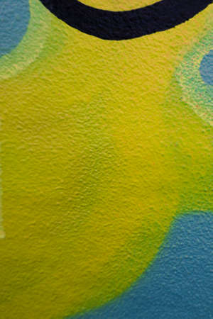 Fragment of the wall with colorful graffiti painting in the street. Part of colorful street art...