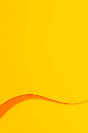 Abstract colored paper texture background. Minimal vertical composition with geometric shapes and lines in yellow and orange colorsの写真素材