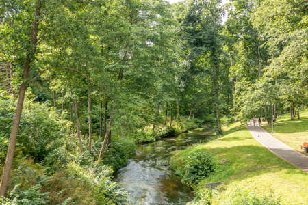 View of urban city park in sunny day in Druskininkai, Lithuania. Druskininkai is resort with health promotion, recreation, active lifestyle, exceptional entertainmentの写真素材