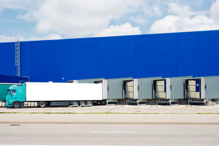 Truck near loading dock of warehouse outdoors. Warehouse area of big shopping centerの写真素材