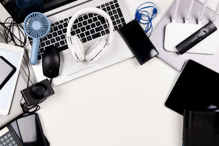 Old laptop computers, digital tablets, mobile phones, many used electronic gadgets devices on white table. Top view. Planned obsolescence, e-waste, electronic waste for recycling conceptの写真素材