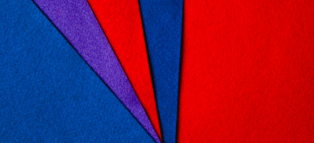 Abstract colorful geometric felt texture background. Bright blue, red, purple colors felt textile for craft. Top view, flat layの写真素材