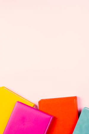 Colorful hardcover books on pastel pink background. Education, self-learning, book swap, bookcrossing concept. Top view, copy space for textの写真素材