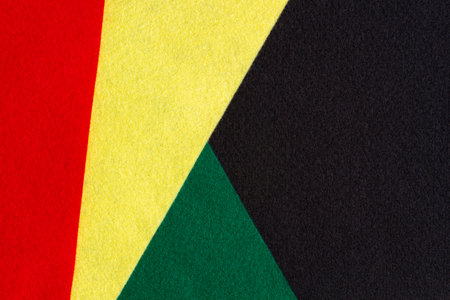Geometric felt fabric textile background in black, red, yellow, green colors. Black History Month color background with copy space for text.の写真素材