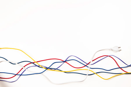 Colorful electrical cord wires cables on white background. Top view, copy space