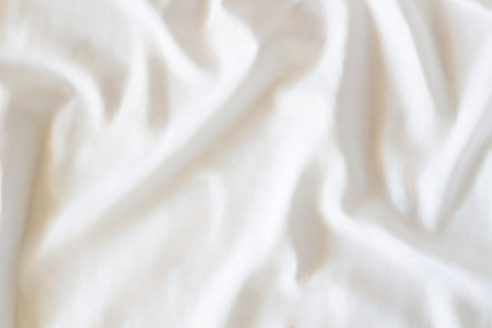White crumpled linen fabric texture background. Natural linen organic eco textiles canvas background. Top viewの写真素材