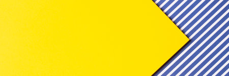 Abstract trendy fashion colored papers texture banner background. Geometric composition with blank yellow paper and striped paper with red, blue, white stripes. Top view, flat lay, copy space for textの写真素材
