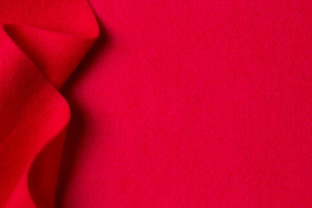 Abstract geometric wool felt texture background. Creative geometric curved red color felt textile background. Top view, copy spaceの写真素材