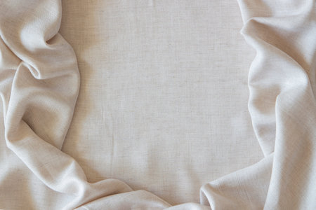 White crumpled linen fabric texture background. Natural off white wavy linen organic eco textiles...