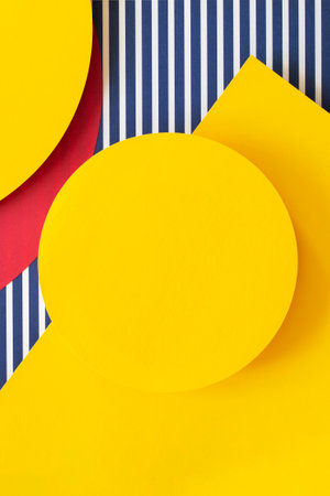 Abstract trendy fashion colored papers texture background in memphis geometry style. Yellow, red, blue, white colors. Geometric shapes and striped lines. Top view, flat layの写真素材