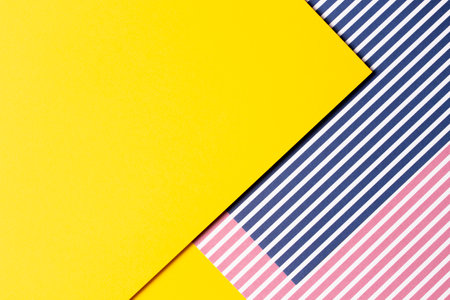 Abstract geometric fashion colored papers texture background. Striped paper with red, blue, white...