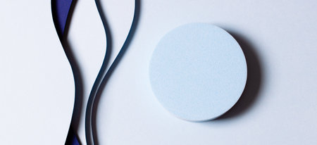 Empty round geometric shape podium platform on paper cut abstract minimal geometric shape blue color background. Abstract pale shade of blue background. Top view mock up for product displayの写真素材