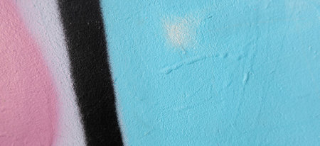 Fragment of old plaster wall with graffiti painting. Part of colorful street art graffiti on wall...