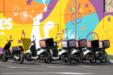 Finestrat, Spain - March 2, 2023: Row of Popeyes delivery scooters at Popeyes restaurant. Popeyes...