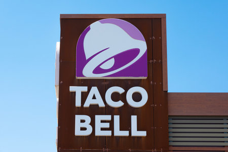 Finestrat, Spain - March 2, 2023: Taco Bell logo on Taco Bell restaurant wall. Taco Bell is American-based chain of fast food restaurants, witch serve variety of Mexican-inspired foodsのeditorial素材