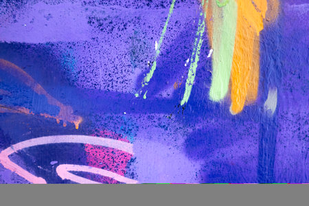 Purple, pink, magenta, white, yellow painted grunge plaster wall surface background with colorful...