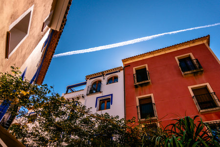 View to Finestrat village street with beautiful colorful houses facades. Alicante province, Spainの写真素材