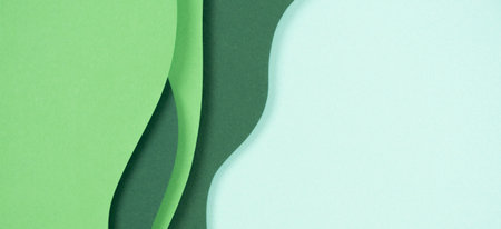 Abstract green color paper texture background. Minimal paper cut style composition with layers of geometric shapes and lines in green tone shades. Top viewの写真素材