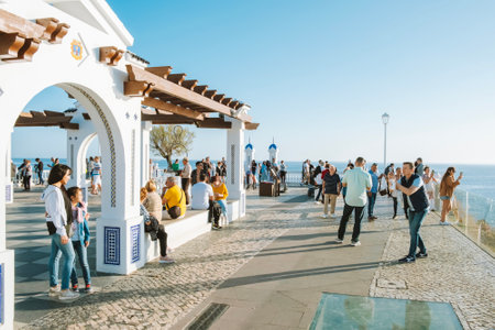 Benidorm, Spain - April 01, 2023: People enjoy sunny evening in Benidorm resort. View to to Balcon del Mediterraneo, Plaza del Castillo in Benidorm old townのeditorial素材