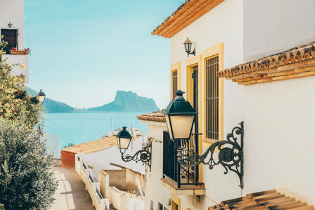 Altea old town with narrow streets and whitewashed houses in Alicante province, Valencian Community, Spain. Small picturesque village of Altea with Mediterranean sea and Ifach rock in backgroundの写真素材