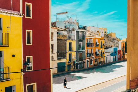 La Vila Joiosa, Spain- March 28, 2023: View to beautiful Villajoyosa street with multi-colored houses. Villajoyosa - coastal town in Alicante Province, Valencian Community, Spain, by Mediterranean Seaのeditorial素材