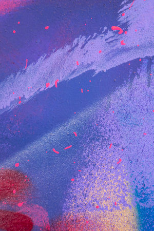 Messy paint strokes and smudges on an old painted wall background. Abstract wall surface with part of graffiti. Colorful drips, flows, streaks of paint and paint spraysの写真素材