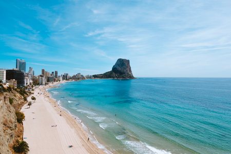 View to Mediterranean Sea with white sand beach, famous Rock Penon de Ifach in Calp, Alicante province, Valencian Community, Spainの写真素材