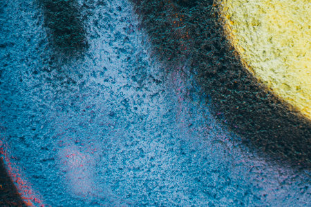 Fragment of the wall with graffiti painting. Part of colorful street art graffiti on wall background